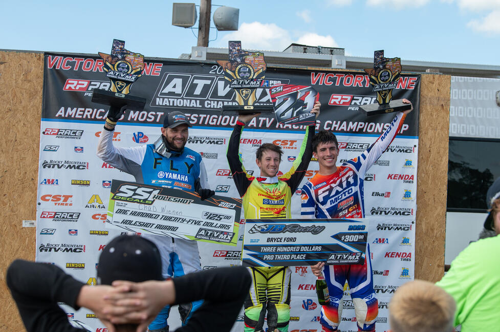 Joel Hetrick (center), Chad Wienen (left) and Bryce Ford (right) atop the podium at round three, Underground MX ATVMX National.